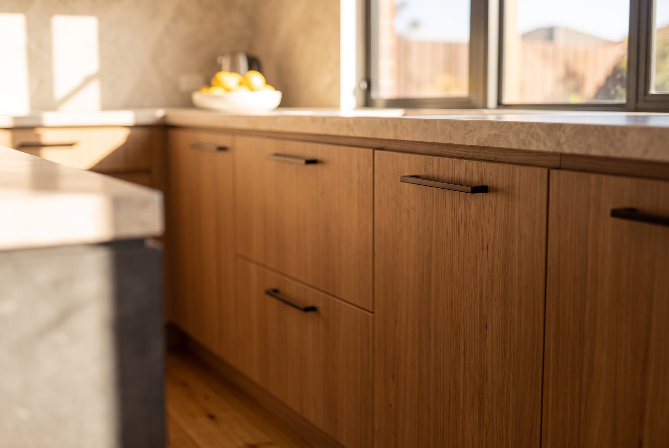 AI concept visualisation: timber cabinetry fronts and black pulls in the kitchen
